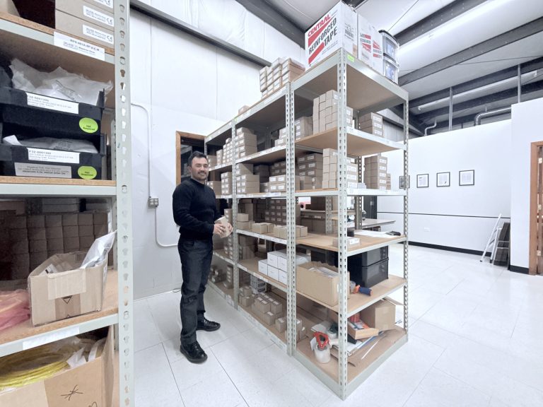 An employee at Migatron selecting a ultrasonic sensor